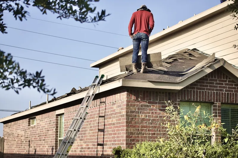 Professional roofer working on a residential roof in Warehouse Point